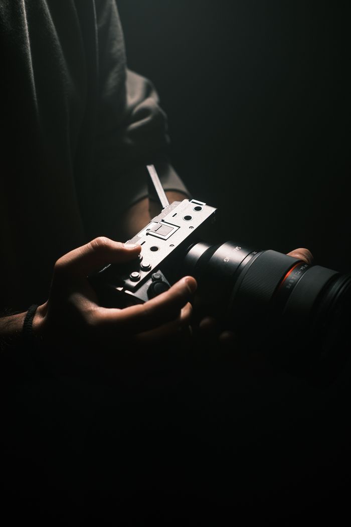 About Close-up of professional filmmaking gear in a dramatic low light setting.